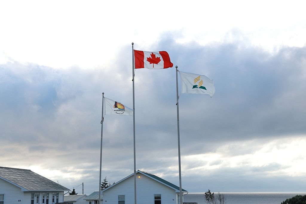 Campground flags featuring the camp logo, Canadian flag, and Seventh-Day Adventist flag.